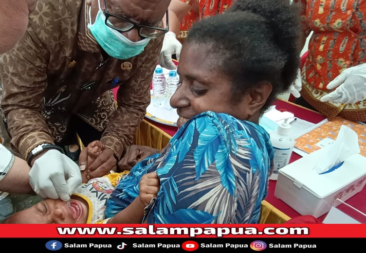 Bupati Mimika Johannes Rettob saat memberikan tetesan polio kepada salah satu balita (salampapua.com/Abeth)
